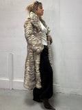 Real long fur coat worn by model in neutral tones, side view