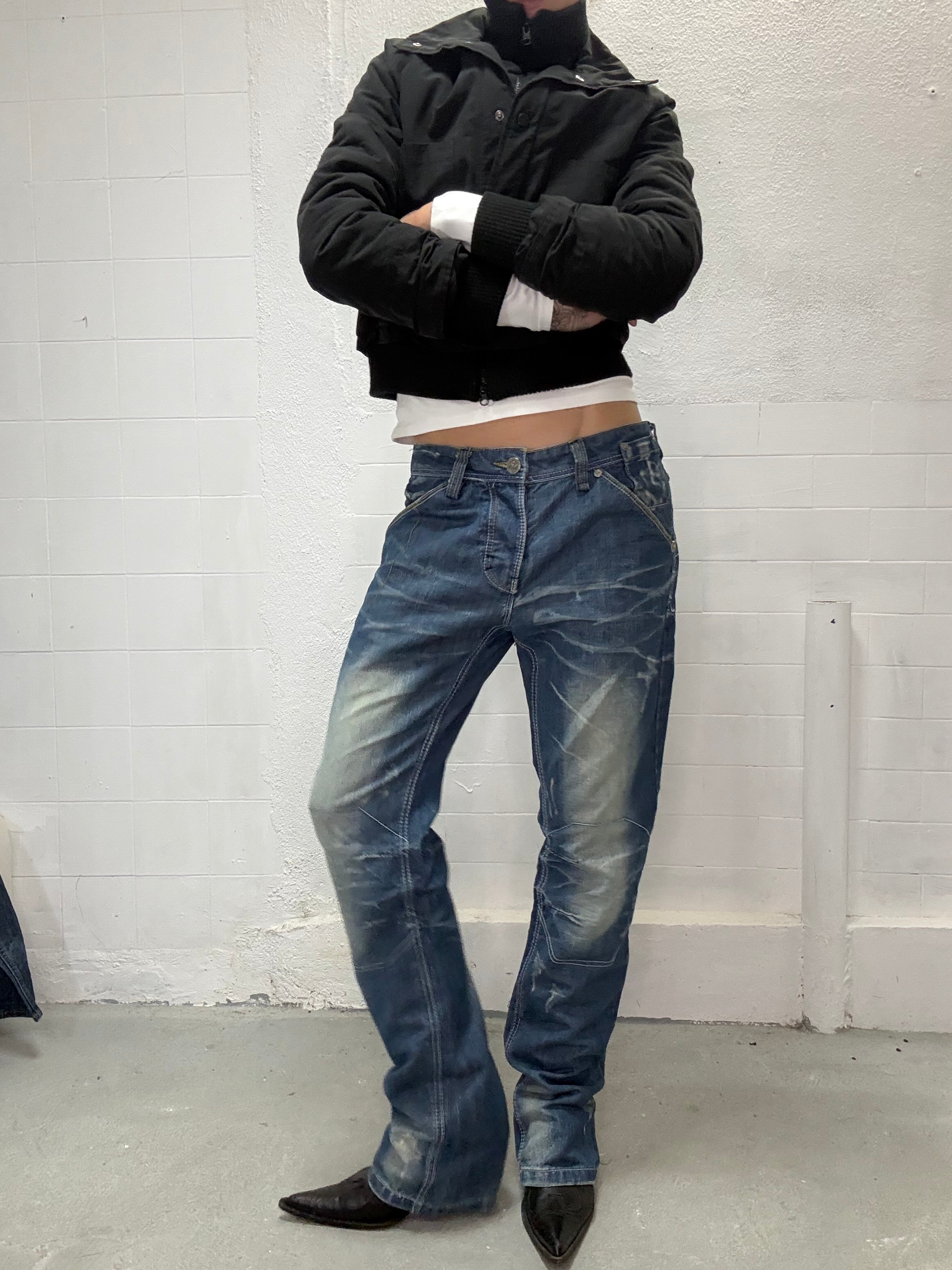 Vintage washed jeans with detailed panels and aged finish front view