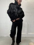 Black real fur coat worn by model, front view