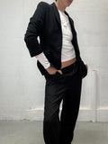 Tailored black blazer worn by model