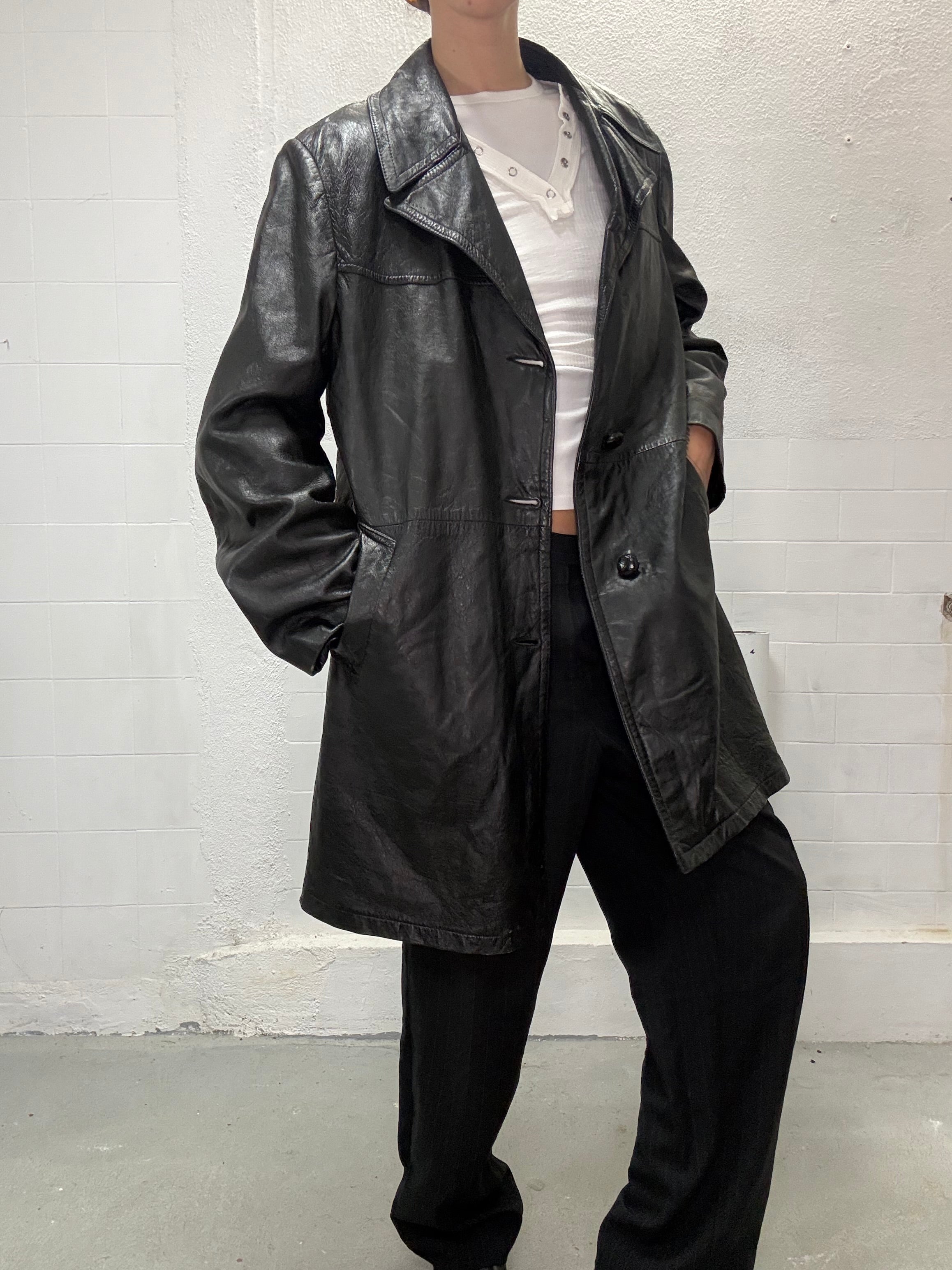 Classic black leather trench coat worn by model